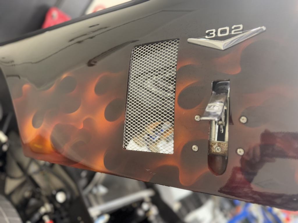 Close detail of the Factory Five Daytona replica flame paint and 302 badge