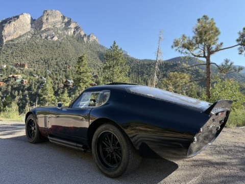Rear hatch view of the Factory Five Daytona replica in the mountains