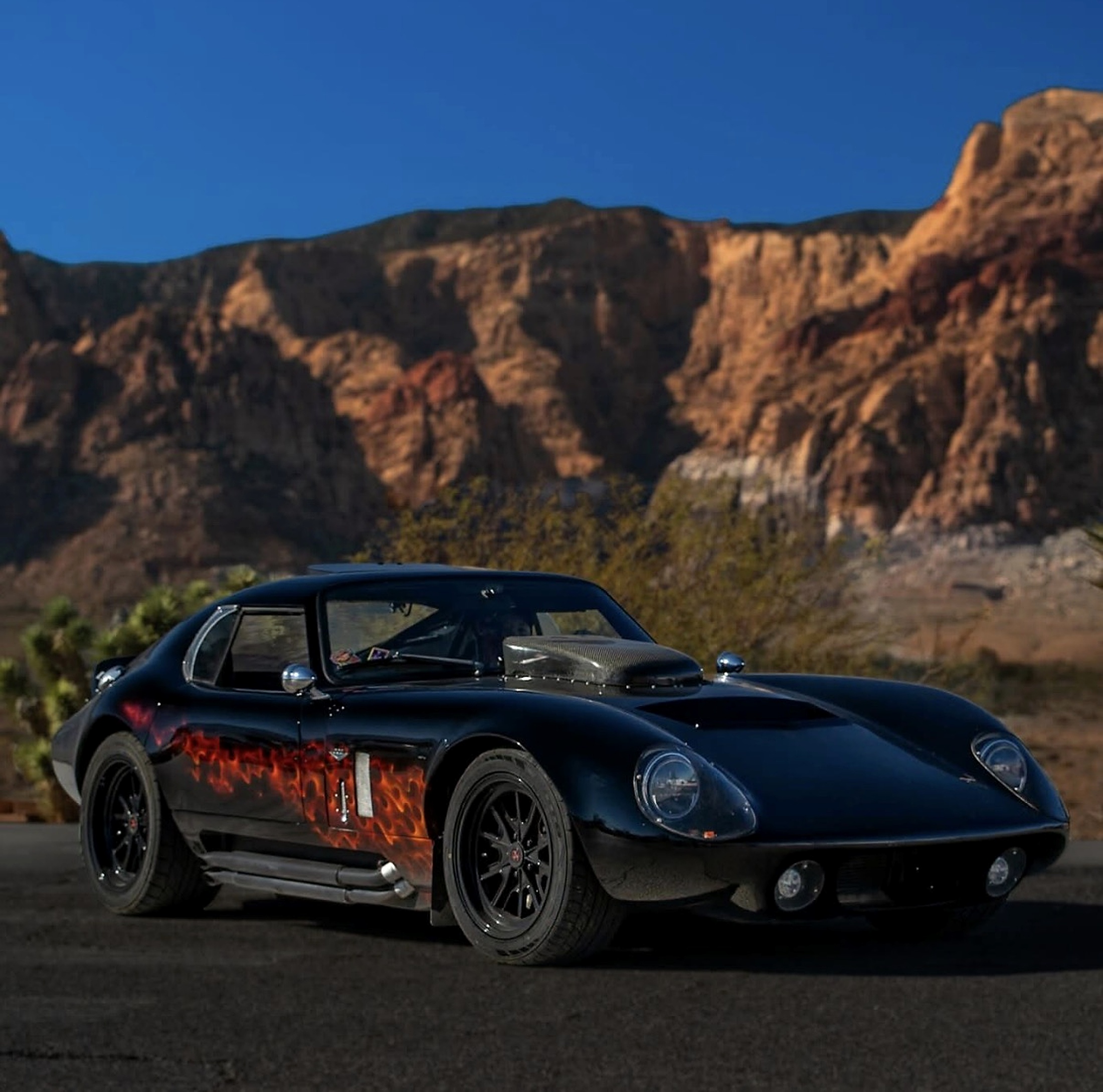 Factory Five 1965 Daytona replica parked in front of red rock cliffs